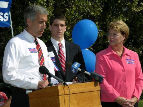 Chris Lauzen on the podium with his son, Rob, and his wife, Sarah.