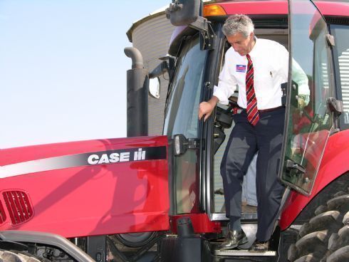 Chris emerges from the tractor cab following his tour of the Brummel farm in Plano.